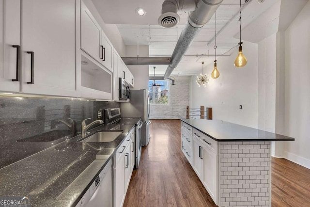 kitchen with dark wood-type flooring, visible vents, white cabinetry, and appliances with stainless steel finishes