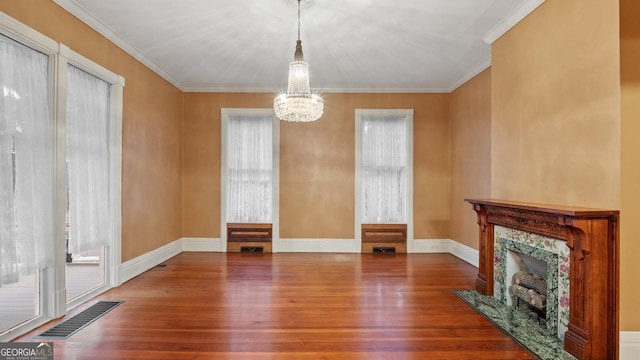 316 E 3rd Ave, Rome, GA 30161 - unfurnished dining area featuring wood finished floors, a chandelier, ornamental molding, baseboards, and healthy amount of natural light