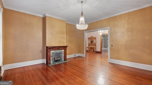 316 E 3rd Ave, Rome, GA 30161 - unfurnished living room with a chandelier, wood finished floors, baseboards, and crown molding