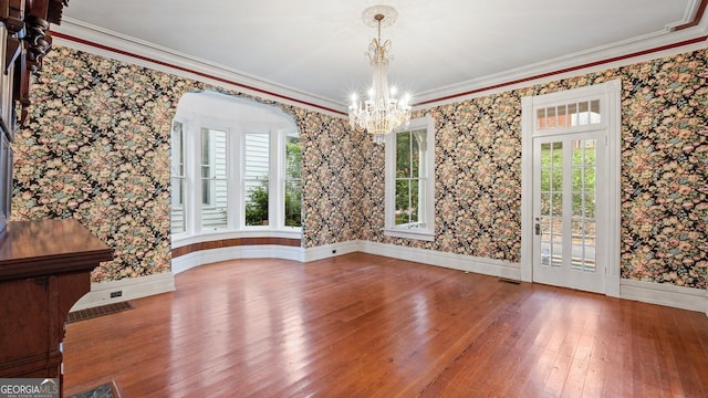 316 E 3rd Ave, Rome, GA 30161 - unfurnished dining area featuring hardwood / wood-style flooring, a chandelier, wallpapered walls, ornamental molding, and baseboards