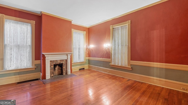 316 E 3rd Ave, Rome, GA 30161 - unfurnished living room featuring wood finished floors, a fireplace with flush hearth, baseboards, and crown molding