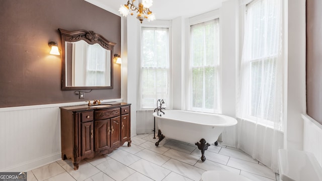 316 E 3rd Ave, Rome, GA 30161 - full bathroom with plenty of natural light, a freestanding tub, vanity, a chandelier, and a wainscoted wall