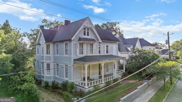 316 E 3rd Ave, Rome, GA 30161 - victorian house featuring covered porch, roof with shingles, and a chimney