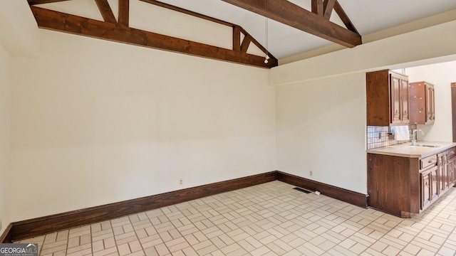 316 E 3rd Ave, Rome, GA 30161 - kitchen featuring a sink, brick patterned floors, light countertops, baseboards, and beamed ceiling