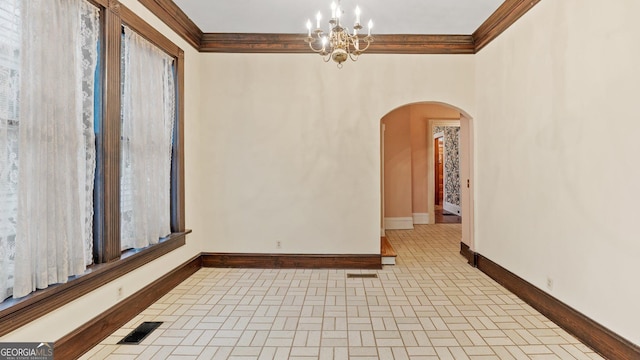 316 E 3rd Ave, Rome, GA 30161 - empty room with arched walkways, ornamental molding, baseboards, brick patterned flooring, and a chandelier