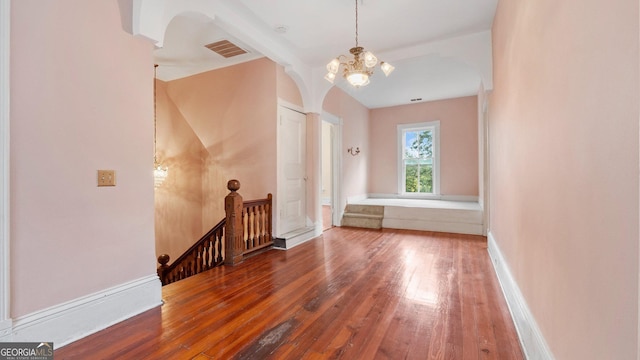 316 E 3rd Ave, Rome, GA 30161 - additional living space with hardwood / wood-style floors, a chandelier, and arched walkways