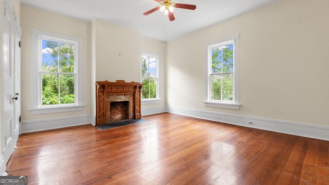 316 E 3rd Ave, Rome, GA 30161 - unfurnished living room with a ceiling fan, wood finished floors, a fireplace with flush hearth, and baseboards