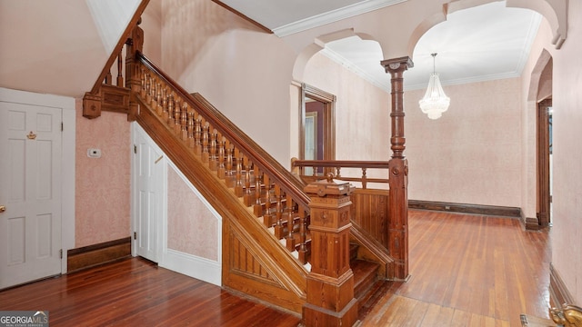 316 E 3rd Ave, Rome, GA 30161 - staircase with hardwood / wood-style floors, arched walkways, wallpapered walls, and crown molding