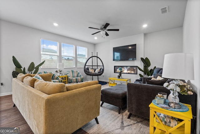 living area with visible vents, recessed lighting, a ceiling fan, and wood finished floors