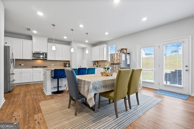 dining space with visible vents, recessed lighting, and light wood-style floors