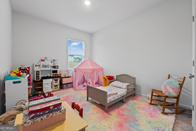 recreation room with baseboards and carpet floors