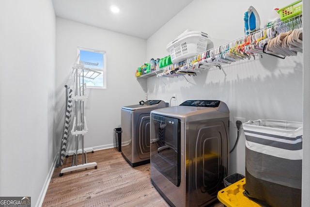 laundry area featuring baseboards, laundry area, recessed lighting, light wood finished floors, and washing machine and clothes dryer