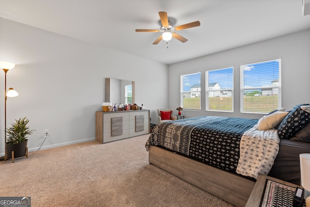 bedroom featuring ceiling fan, baseboards, and carpet
