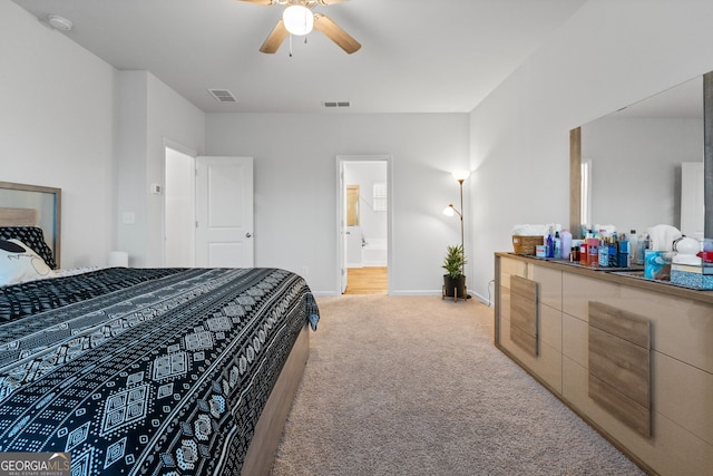 bedroom featuring visible vents, baseboards, a ceiling fan, and light carpet