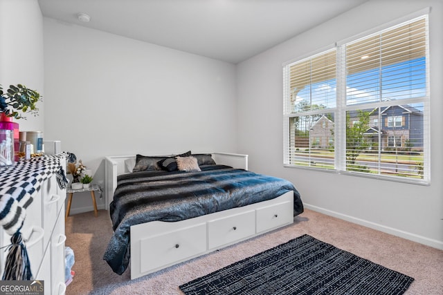 carpeted bedroom with baseboards