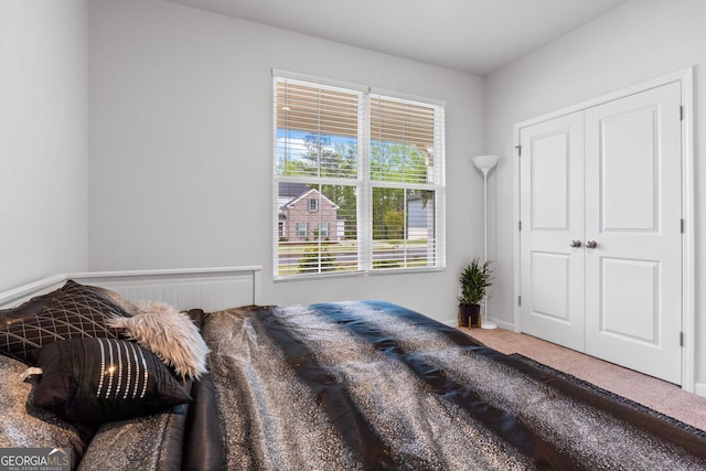 bedroom with carpet flooring and baseboards