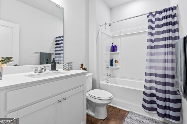 full bath featuring toilet, wood finished floors, vanity, and shower / tub combo with curtain