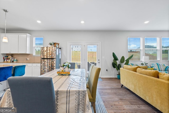 dining space with a wealth of natural light, recessed lighting, and wood finished floors