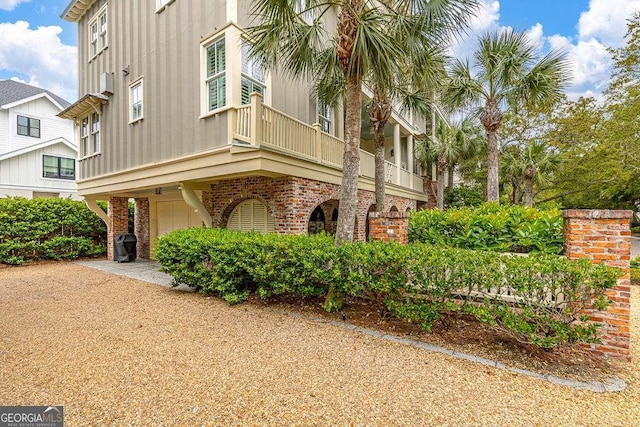 17 Sea Oats Ln, Saint Simons, GA 31522 - exterior space with brick siding, a garage, and board and batten siding