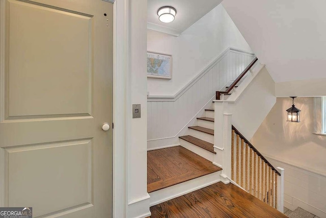 17 Sea Oats Ln, Saint Simons, GA 31522 - stairway featuring a wainscoted wall and wood finished floors