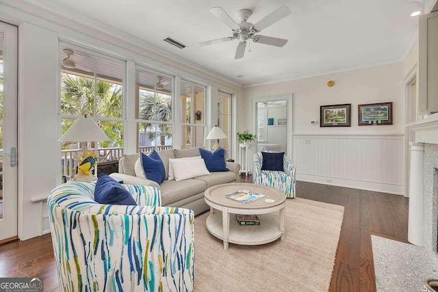 17 Sea Oats Ln, Saint Simons, GA 31522 - living room with visible vents, ornamental molding, ceiling fan, dark wood finished floors, and wainscoting