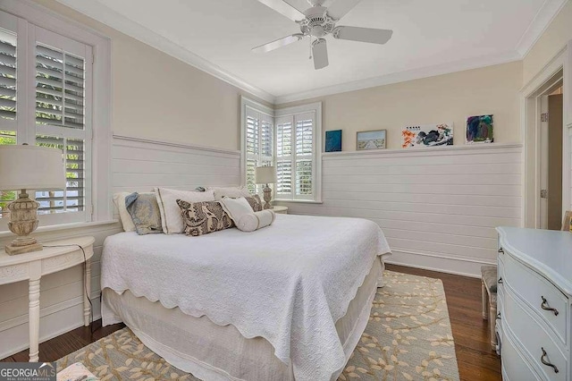 17 Sea Oats Ln, Saint Simons, GA 31522 - bedroom featuring dark wood-style floors, crown molding, multiple windows, and a wainscoted wall