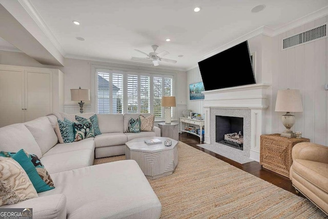 17 Sea Oats Ln, Saint Simons, GA 31522 - living room featuring visible vents, a ceiling fan, crown molding, wood finished floors, and a fireplace with flush hearth