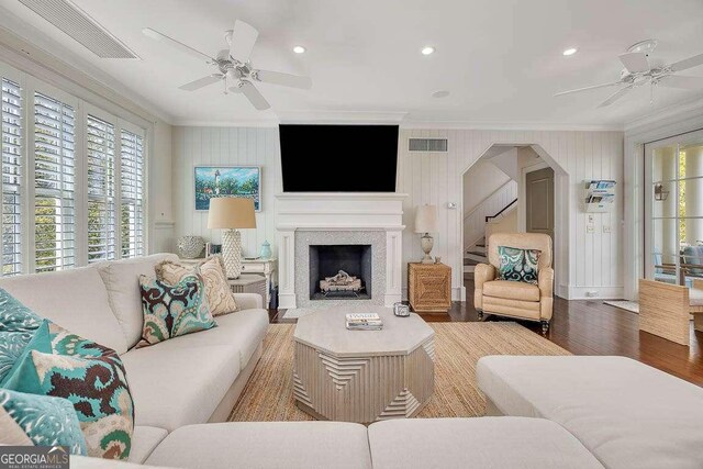 17 Sea Oats Ln, Saint Simons, GA 31522 - living area with ornamental molding, ceiling fan, visible vents, and a fireplace with flush hearth