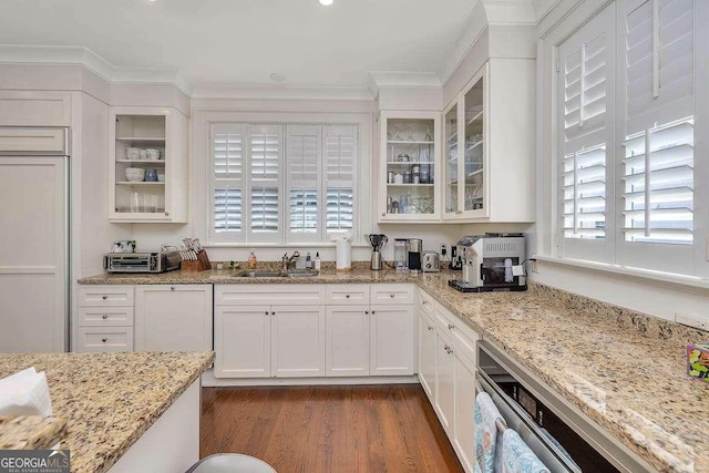 17 Sea Oats Ln, Saint Simons, GA 31522 - kitchen featuring a sink, ornamental molding, dark wood-style flooring, paneled refrigerator, and white cabinetry