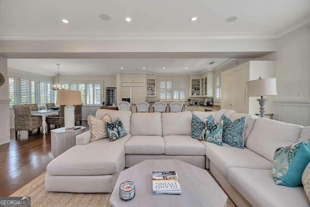 17 Sea Oats Ln, Saint Simons, GA 31522 - living area featuring an inviting chandelier, ornamental molding, recessed lighting, a wainscoted wall, and wood finished floors