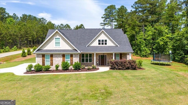 41 Laurel Rdg, Forsyth, GA 31029 - craftsman house with a trampoline, a front lawn, and brick siding