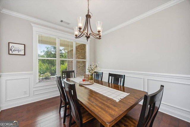 41 Laurel Rdg, Forsyth, GA 31029 - dining area with a chandelier, ornamental molding, dark wood-style flooring, a decorative wall, and wainscoting
