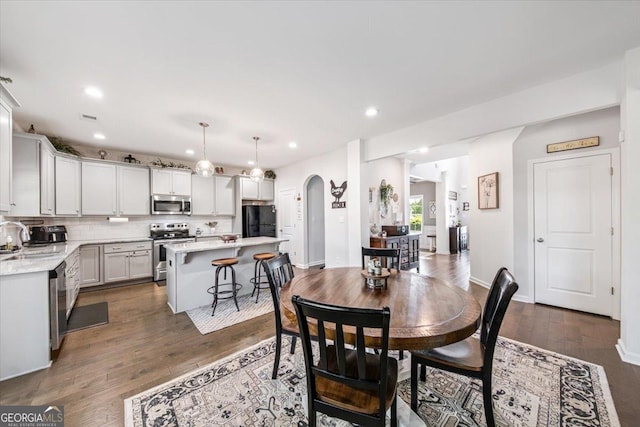 5321 Felles Way, Forsyth, GA 31029 - dining area featuring arched walkways, recessed lighting, and dark wood finished floors