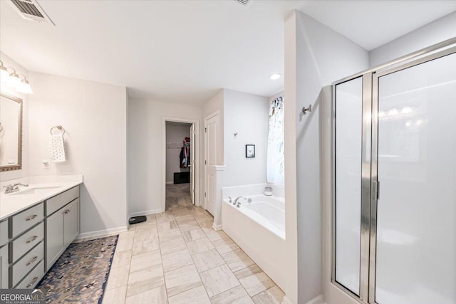 5321 Felles Way, Forsyth, GA 31029 - bathroom featuring a shower stall, vanity, a bath, a spacious closet, and recessed lighting