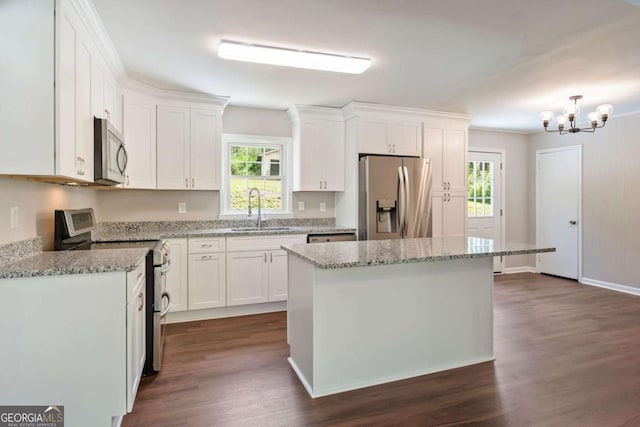 2125 Perkerson Mill Rd, Austell, GA 30106 - kitchen with white cabinets, a center island, an inviting chandelier, a sink, and appliances with stainless steel finishes