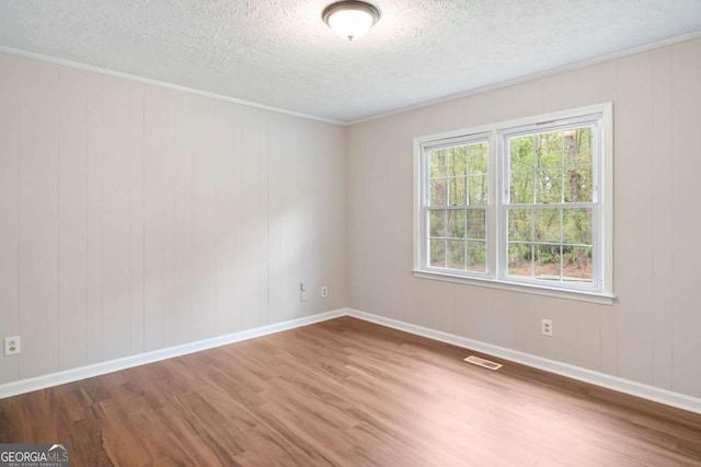 2125 Perkerson Mill Rd, Austell, GA 30106 - unfurnished room with wood finished floors, a textured ceiling, baseboards, and crown molding