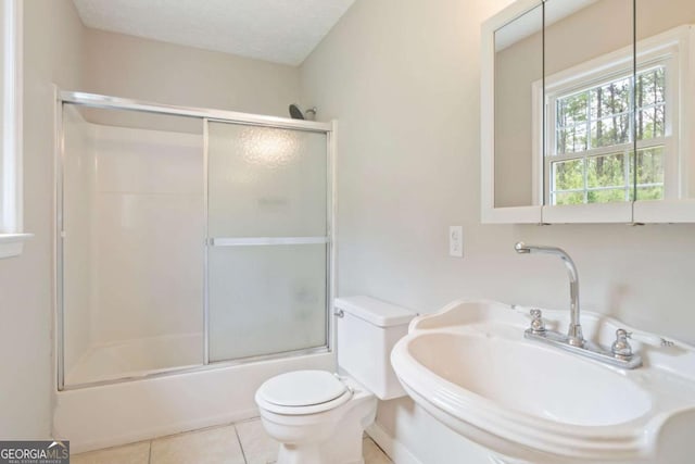 2125 Perkerson Mill Rd, Austell, GA 30106 - full bathroom featuring toilet, tile patterned flooring, combined bath / shower with glass door, and a sink