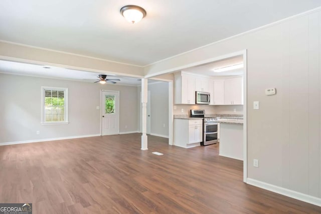 2125 Perkerson Mill Rd, Austell, GA 30106 - unfurnished living room featuring crown molding, baseboards, a ceiling fan, and dark wood finished floors