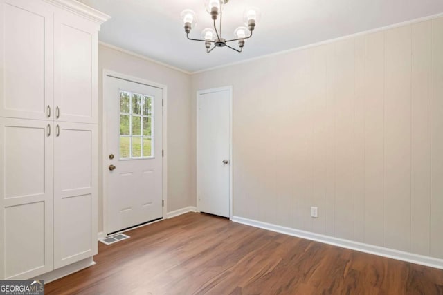 2125 Perkerson Mill Rd, Austell, GA 30106 - doorway featuring a chandelier, wood finished floors, baseboards, and ornamental molding