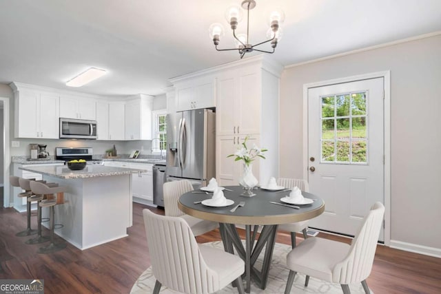 2125 Perkerson Mill Rd, Austell, GA 30106 - dining space with healthy amount of natural light, a chandelier, dark wood-type flooring, crown molding, and baseboards