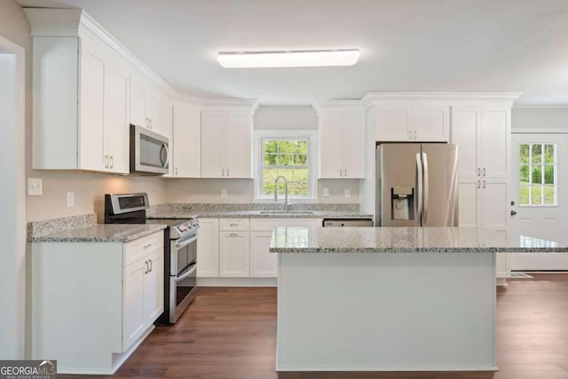 2125 Perkerson Mill Rd, Austell, GA 30106 - kitchen featuring a sink, white cabinets, appliances with stainless steel finishes, and a healthy amount of sunlight