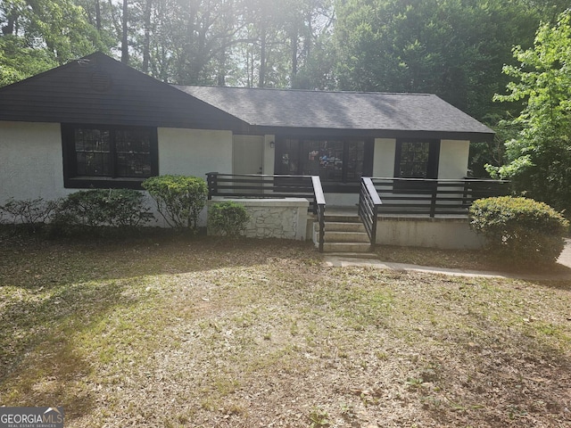 single story home with covered porch and stucco siding
