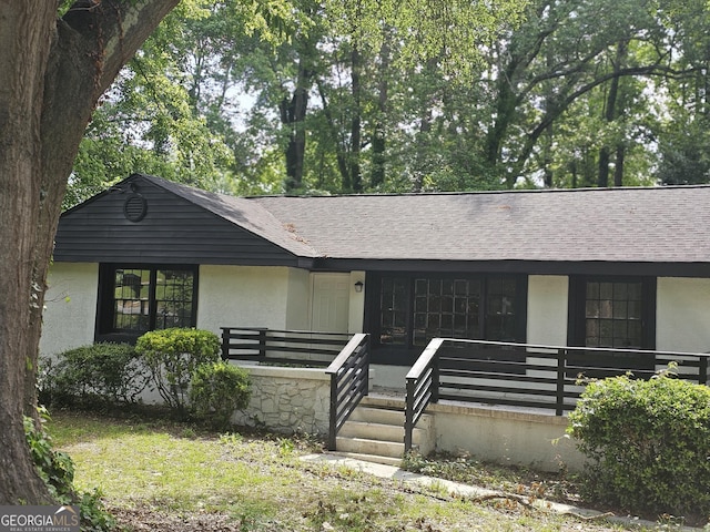 1956 Shirley St SW, Atlanta, GA 30311 - view of front of property featuring a shingled roof, stucco siding, and covered porch