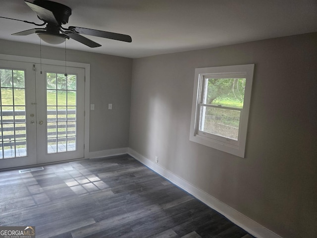 spare room with french doors, a ceiling fan, visible vents, dark wood finished floors, and baseboards