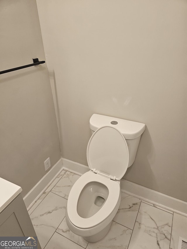 1956 Shirley St SW, Atlanta, GA 30311 - bathroom featuring marble finish floors, baseboards, toilet, and vanity
