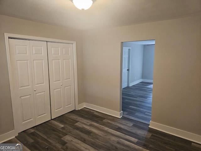 1956 Shirley St SW, Atlanta, GA 30311 - unfurnished bedroom featuring dark wood-style flooring, baseboards, and a closet