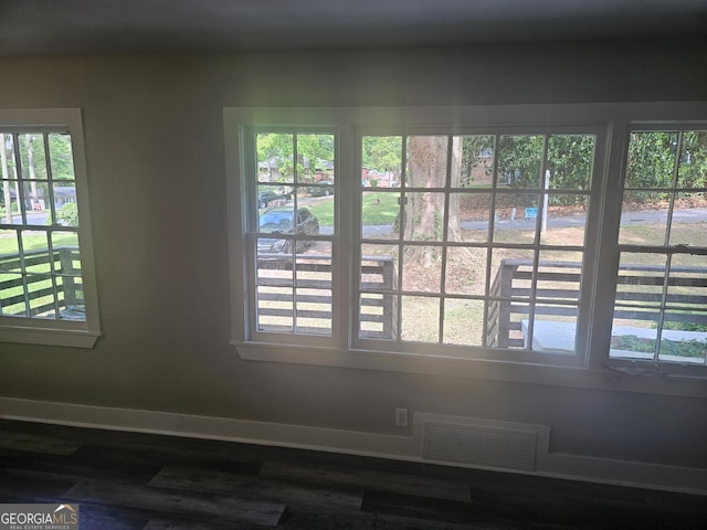 interior details with visible vents, baseboards, and wood finished floors