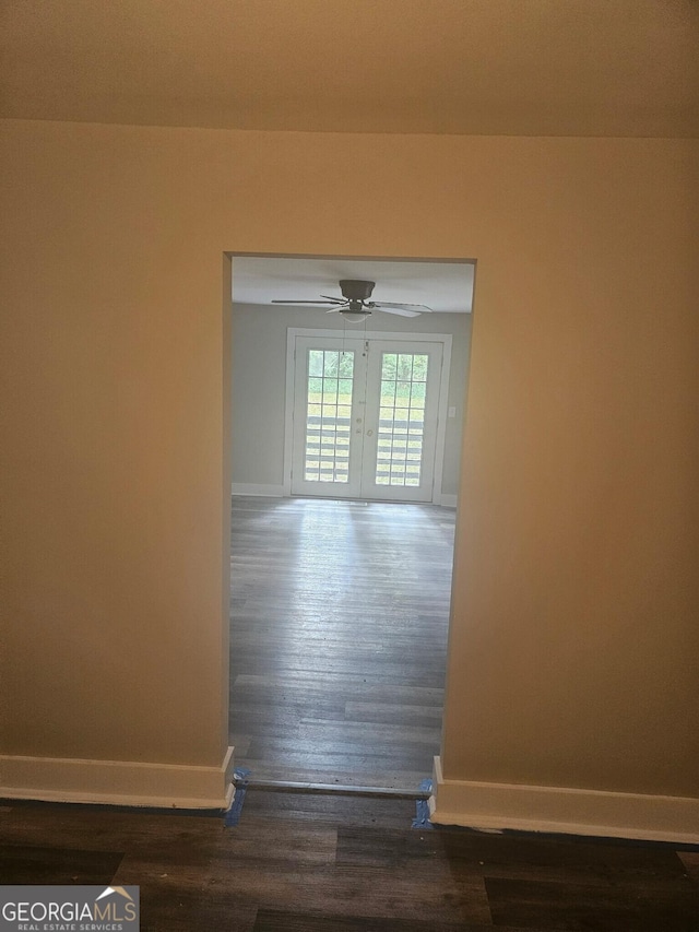 interior space with baseboards and wood finished floors