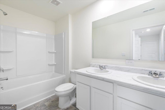 full bath with toilet, visible vents, and a sink