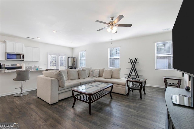 living area with a ceiling fan, dark wood-type flooring, baseboards, visible vents, and recessed lighting